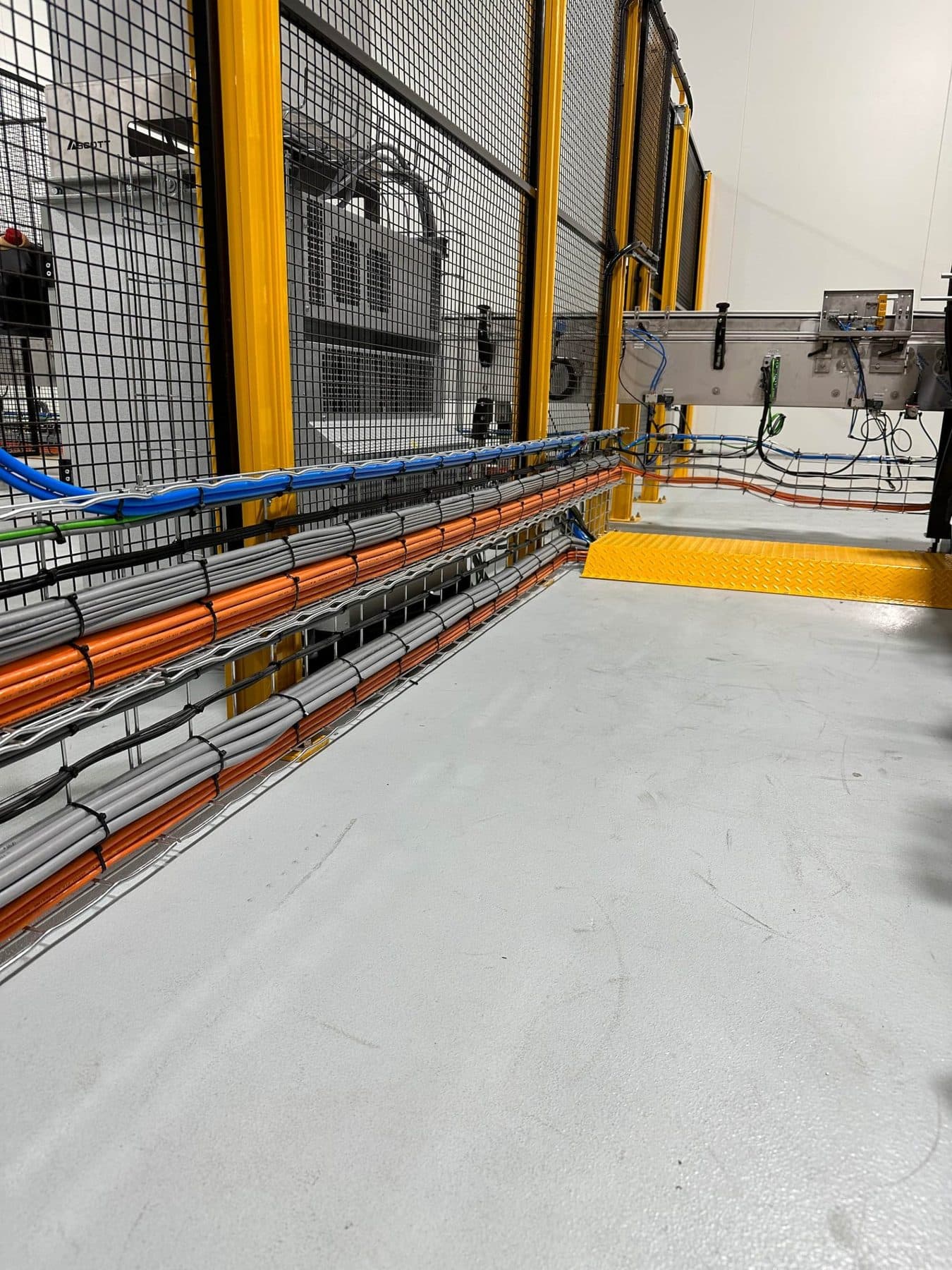 Cable containment running the length of the conveyor system